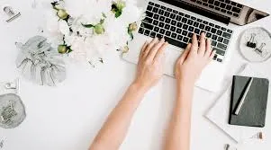Small glass hourglass on wooden tray